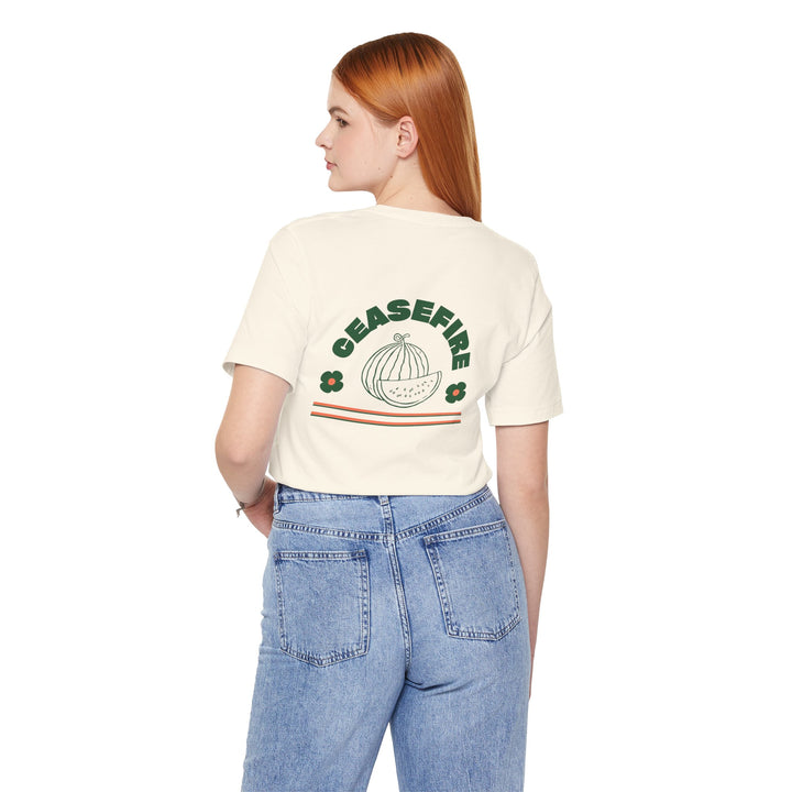 Ceasefire classic tee in Natural worn by a model, back view with Ceasefire watermelon print