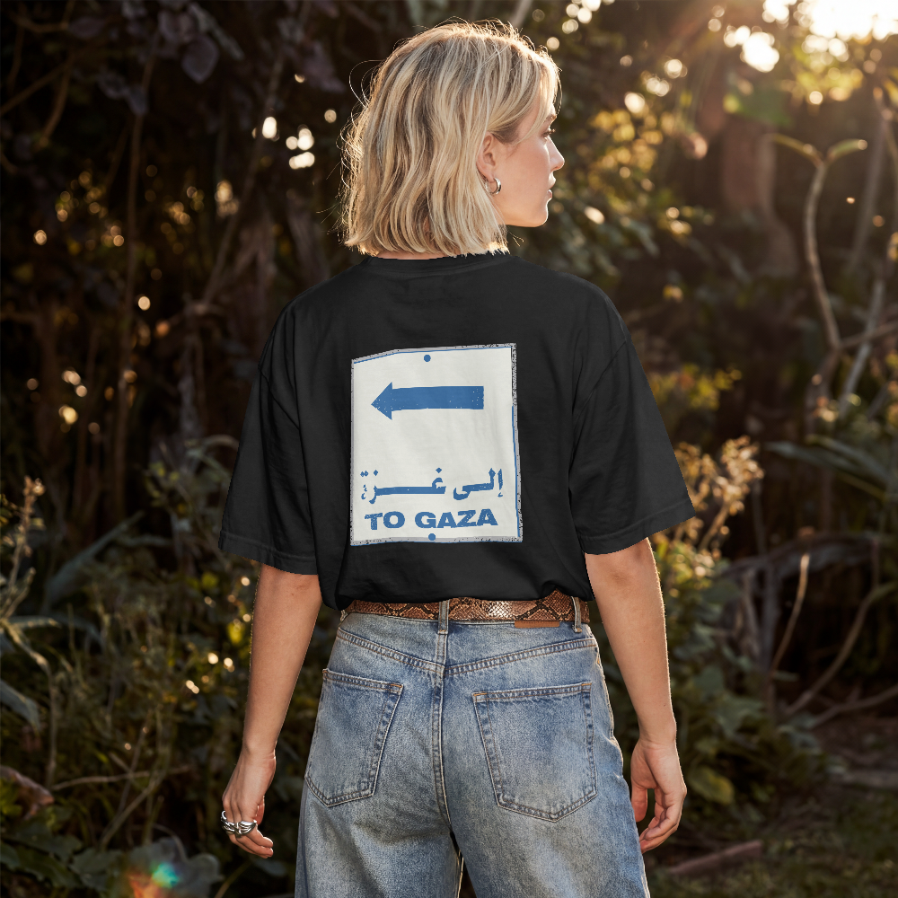 To Gaza box tee in black worn by a model outdoors, back view with To Gaza road sign print