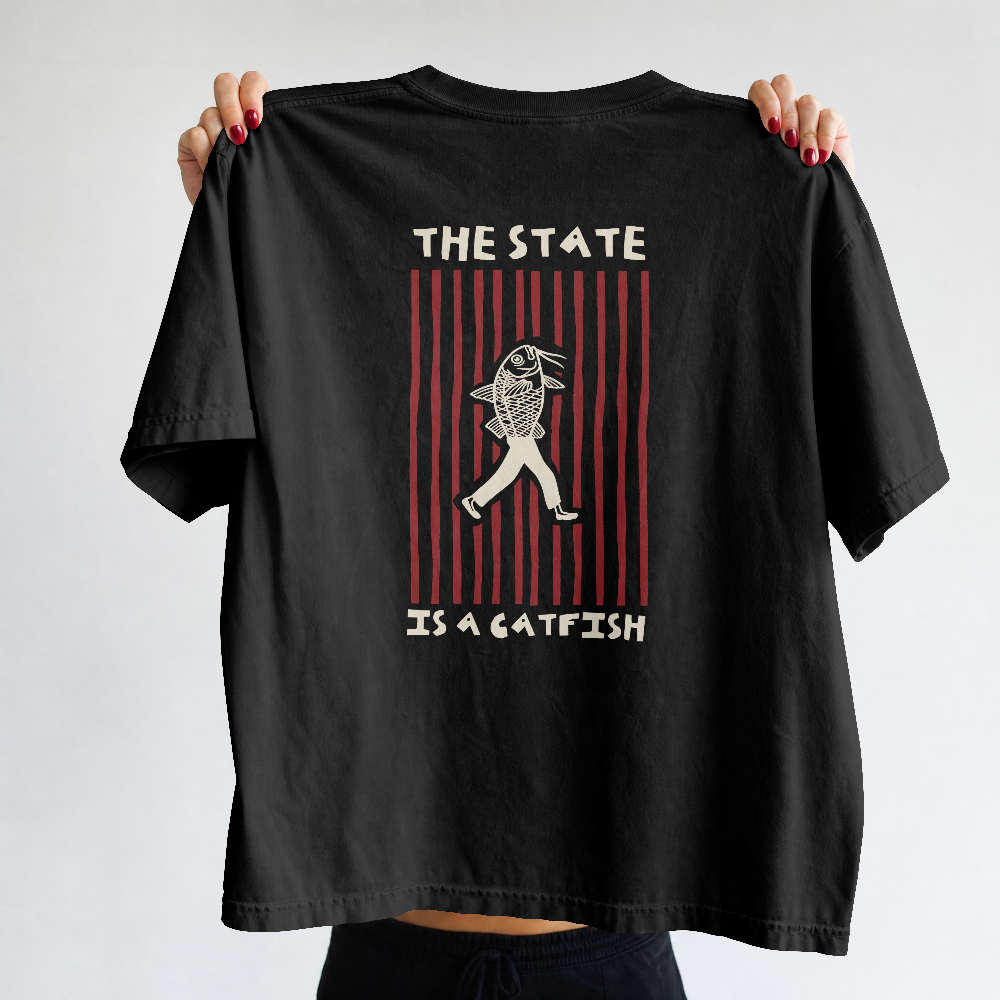 The State is a Catfish box tee in black held up by a model, back view with The State Is a Catfish graphic