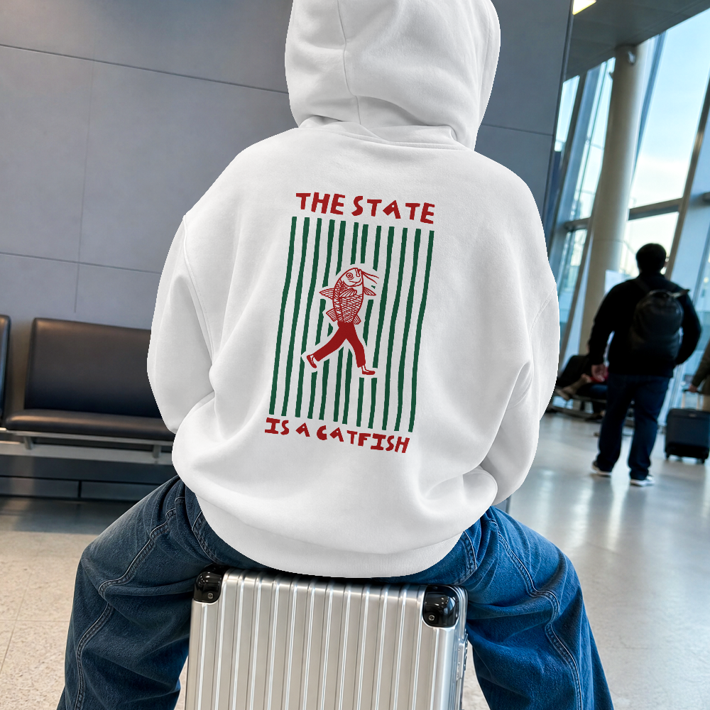 The State is a Catfish hoodie in white worn by a model at an airport, back view with The State Is a Catfish graphic
