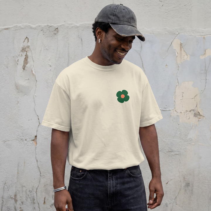 Ceasefire box tee in Vintage White worn by a model, front view with small flower chest print